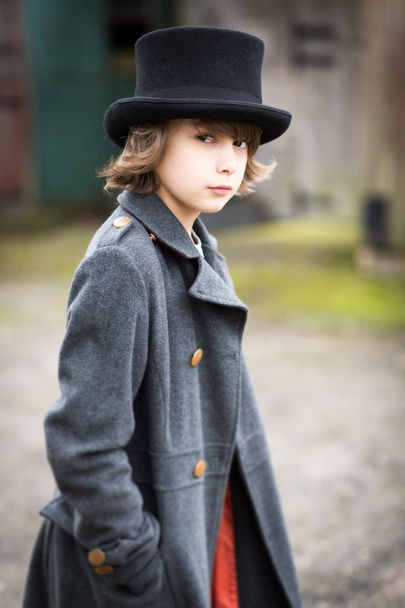 Αγόρι στο μακρύ παλτό και κορυφαίο καπέλο - Φωτογραφία, εικόνα