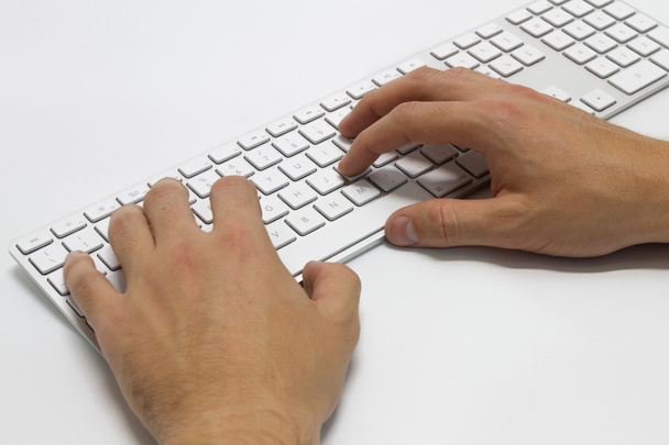 hands typing on the white wireless keyboard - Photo, Image