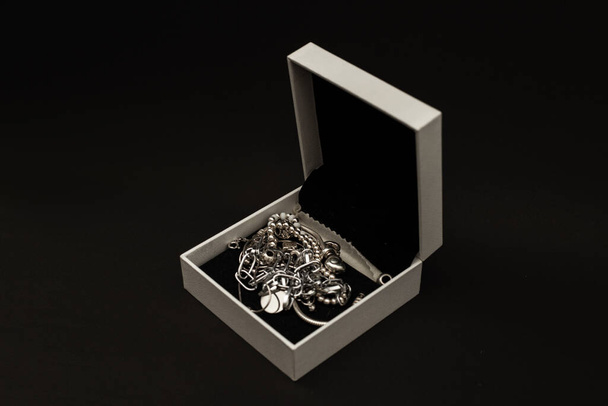 Silver and white gold jewelry in a white box - 写真・画像