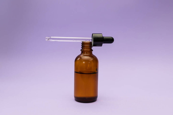 Hair serum, subject shot on purple background - Foto, imagen