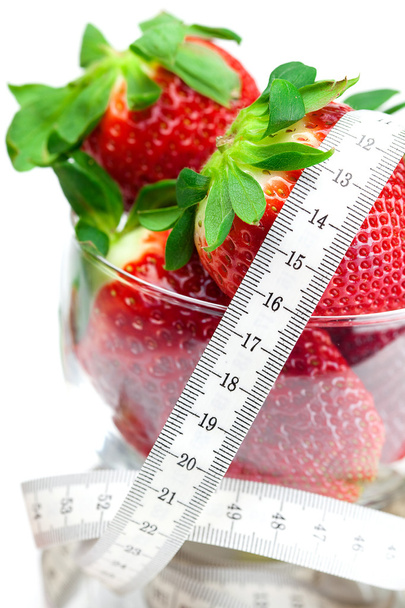 Big juicy red ripe strawberries in a glass bowl and measure tape - Фото, зображення