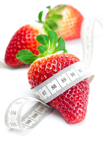 Big juicy red ripe strawberries and measure tape isolated on whi - Фото, зображення