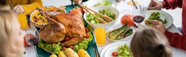 Overhead view of delicious turkey near dinner and family at home, banner  - Фото, зображення