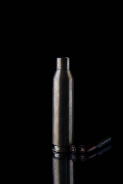 high caliber cartridge case on black background. - Foto, Imagen