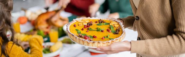 Cropped view of woman holding delicious thanksgiving pie at home, banner  - Zdjęcie, obraz