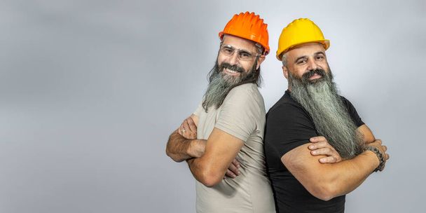 workers with smiling elements on gray background - Photo, Image