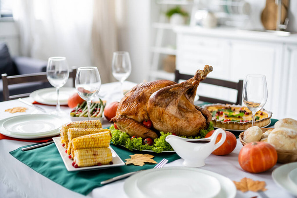 traditional roasted turkey and grilled corn on table served with thanksgiving dinner - Фото, изображение