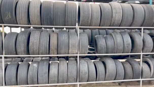Sale of used tires. People use worn tires. Group of used tires for tire repair workshops. Tire tread wear. - Footage, Video