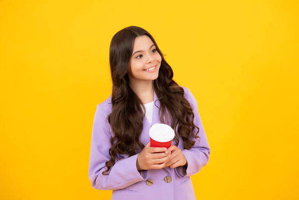 Happy smiling school girl holding coffee cup, learning and education. Coffee break and school recess. Back to school. Teenager student plastic takeaway cup drink cacao or tea beverage - Foto, imagen