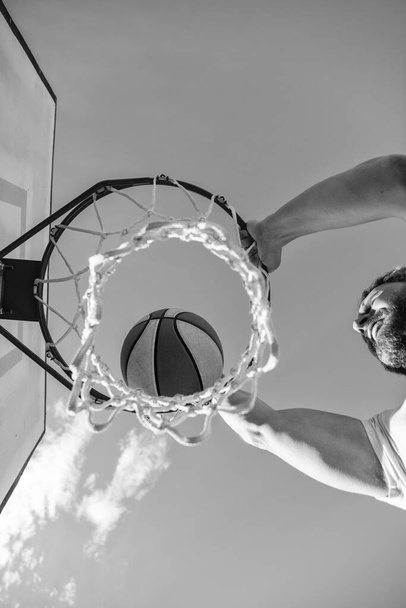 slam dunk in motion. top view. summer activity. man with basketball ball on court. professional basketball player training outdoor. guy has sport motivation. sport and hobby. dunk in basket. - Photo, Image