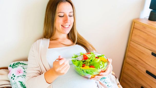Pregnant healthy eating salad. Pregnancy woman eating nutrition healthy food. Healthy breakfast concept - Fotó, kép