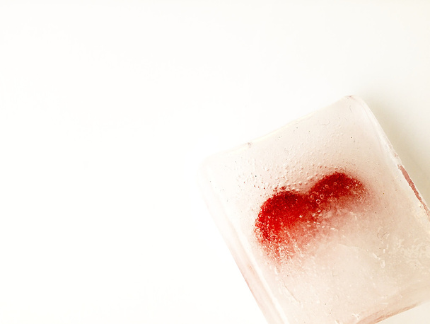 Red heart embedded in ice. - Photo, Image