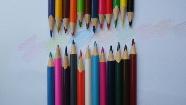 Wooden color pencils arranged in bulk. Color pencils isolated on a white background - Photo, Image