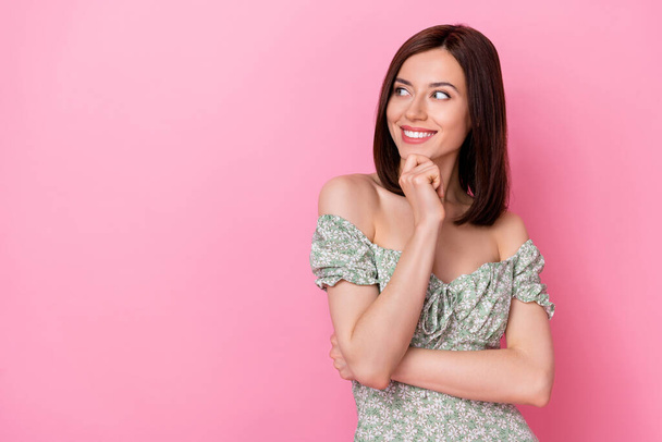 Photo of shiny dreamy lady wear green clothes looking empty space arm chin isolated pink color background. - Photo, image