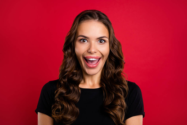 Photo of pretty impressed young woman wear black t-shirt open mouth ready for shopping smiling isolated red color background. - Foto, Bild