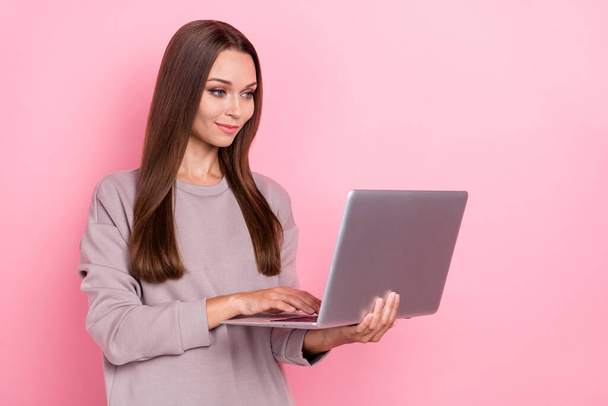 Portrait of pretty positive girl hold use wireless netbook networking isolated on pink color background. - Valokuva, kuva
