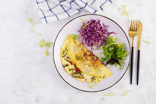 Ketogenic diet breakfast. Omelette with sorrel and fresh salad. Top view, copy space - Fotó, kép