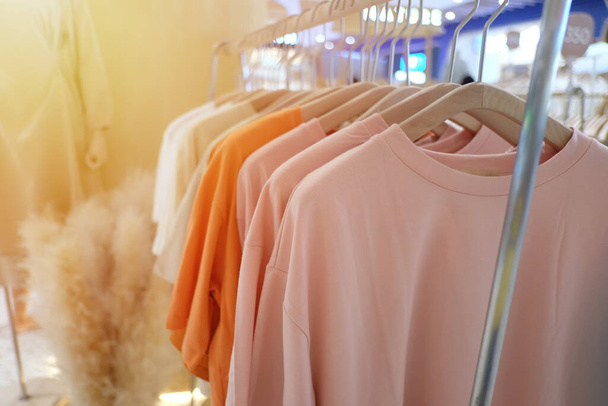 Colorful clothes hanging on clothesline and have orange sunlight shines in the daytime for design in your work. - Photo, Image