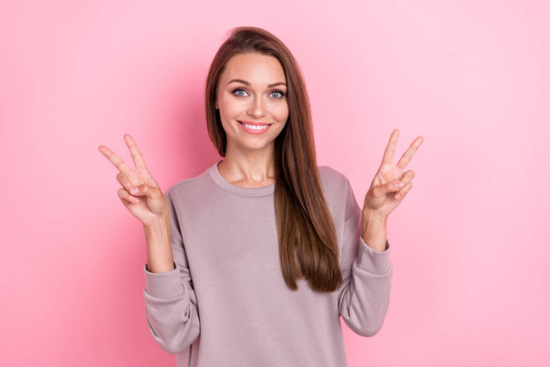 Portrait of adorable nice girl beaming smile two arms fingers show v-sign isolated on pink color background. - Fotografie, Obrázek
