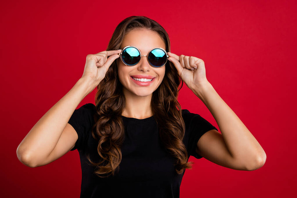 Photo of young charming woman good mood wear eyeglasses trip vacation isolated over red color background. - Foto, afbeelding