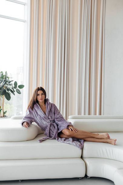 Young relaxed serene woman in spa bathrobe after taking a shower bath resting after hard day. Beauty treatment concept. High quality photo - Φωτογραφία, εικόνα