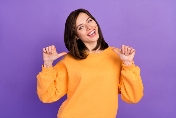 Portrait photo of young pretty adorable pretty lady wear orange shirt toothy smile fingers point herself personal branding successful isolated on violet color background. - Foto, Bild