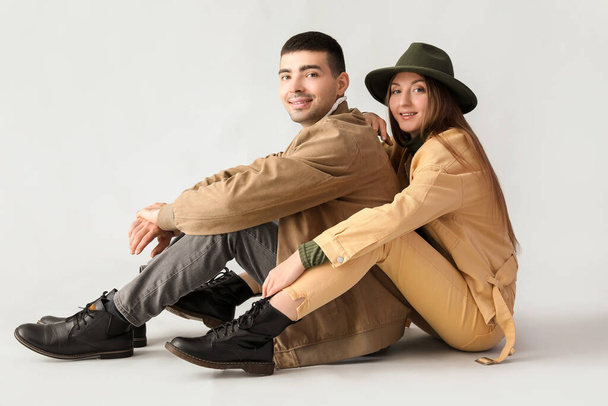 Fashionable young couple in autumn clothes on light background - Photo, Image