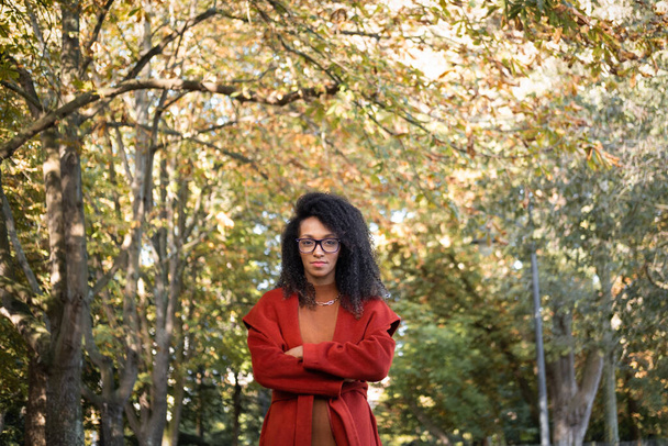 Portrait of stylish black woman wearing eye glasses outdoor at city park. Autumn fashion concept. - Foto, Imagem