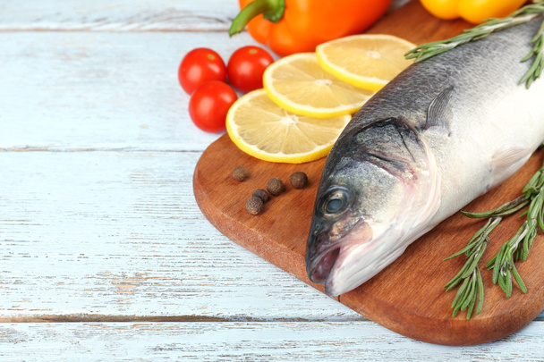 Fresh raw fish and food ingredients on table - Valokuva, kuva