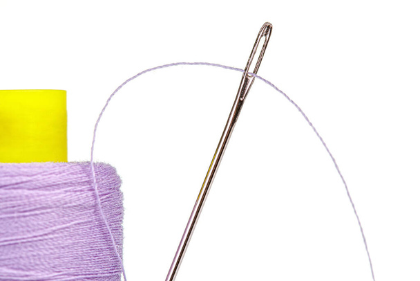 Macro skein of thread purple colors with a needle on a white background close-up - Photo, Image