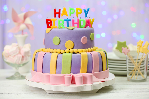 Delicious birthday cake on shiny light background - Φωτογραφία, εικόνα