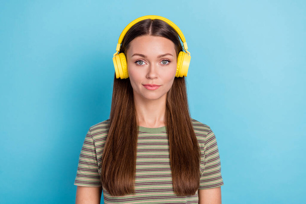 Closeup photo of youngster pretty confident woman wear t-shirt khaki wear headphones listening music pause after work isolated on blue color background. - Foto, afbeelding