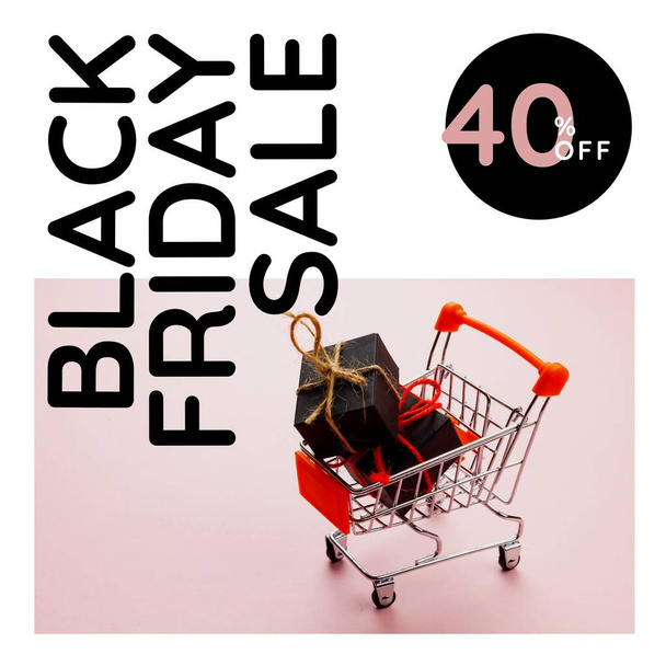 Composition of black friday text over shopping cart with presents. Black friday and celebration concept digitally generated image. - Foto, afbeelding