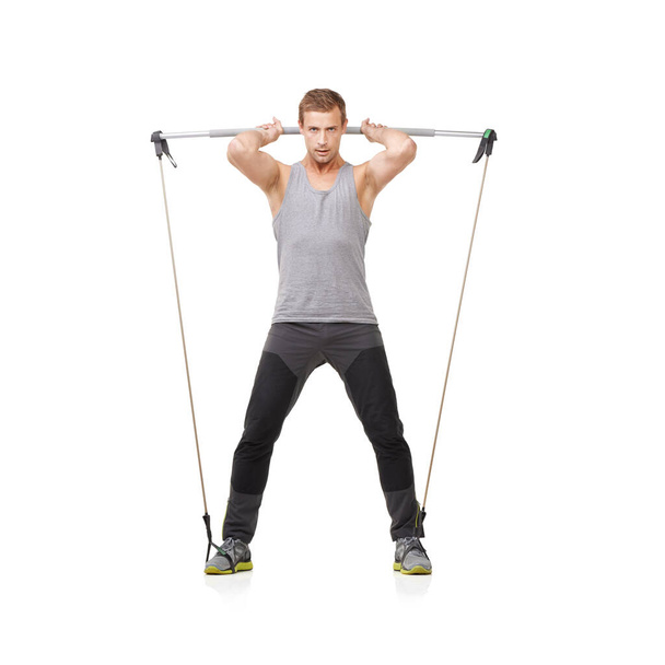 Hes into exercise. A young exercising using a resistance band - Фото, изображение