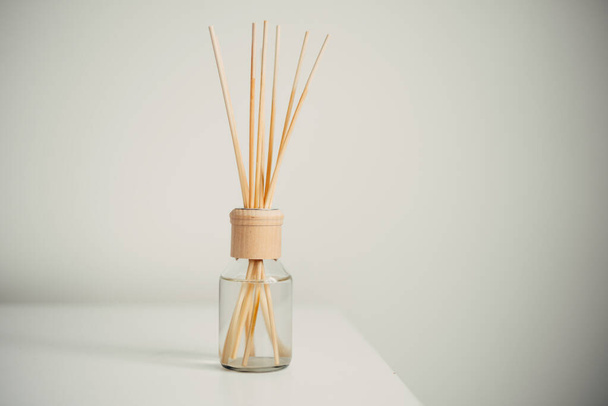 Reed air freshener on table in room home. - Foto, imagen