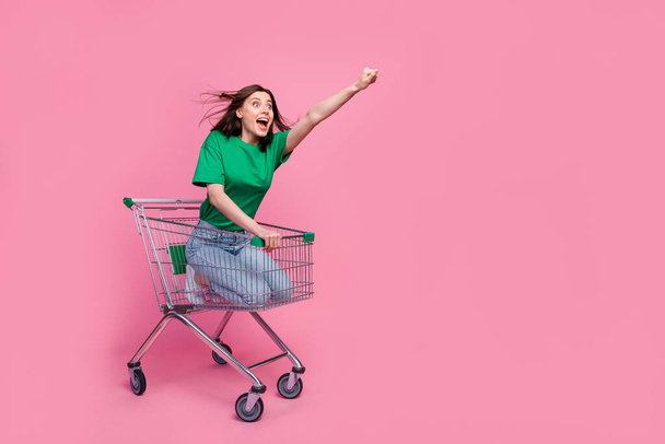 Full size photo of positive carefree lady raise hand look empty space isolated on pink color background. - 写真・画像