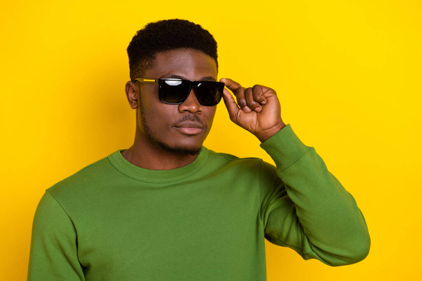 Portrait of attractive content guy dandy touching specs good look isolated over bright yellow color background. - Fotografie, Obrázek