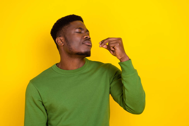 Portrait of attractive dreamy calm guy tasting invisible dinner isolated on bright yellow color background. - Fotoğraf, Görsel