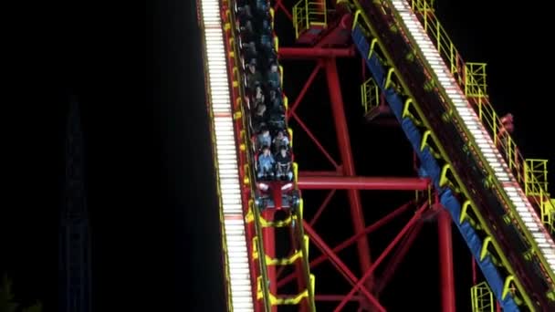 Roller coaster at night in a city amusement park. - Footage, Video