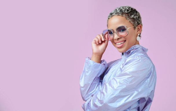 Fashion, sunglasses and black woman in vaporwave jacket on pink background in studio mock up space advertising and marketing. Gen z girl or young model with retro or vintage style portrait mockup. - Photo, Image