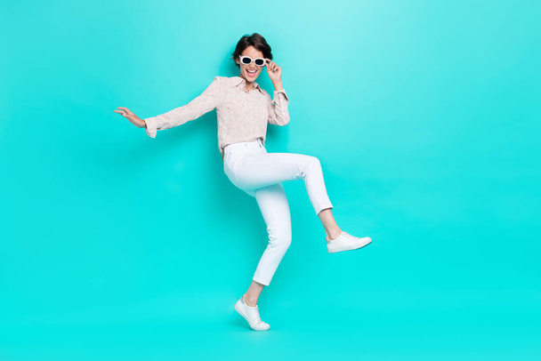 Full length hoto of pretty lady stylish clothes hand touch eyewear enjoy weekend relax rest empty space isolated on cyan color background. - Фото, изображение