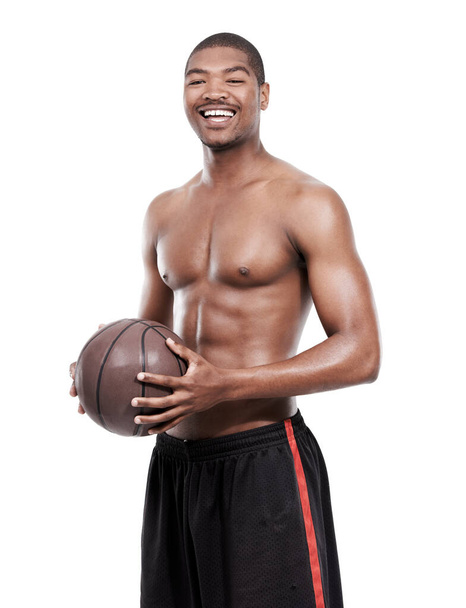 Hes a top athlete. Portrait of a handsome young basketball player standing shirtless in the studio - Φωτογραφία, εικόνα