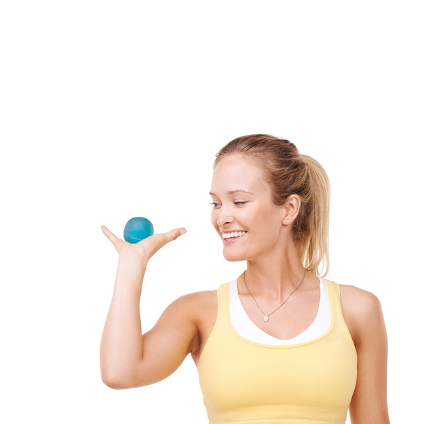 This is my little stress-reliever. Cropped view of a woman squeezing a stress ball against a white background - 写真・画像