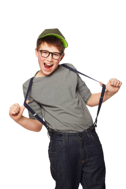 Rocking his suspenders. A teenage boy wearing a hat and glasses while pulling his suspenders - Zdjęcie, obraz