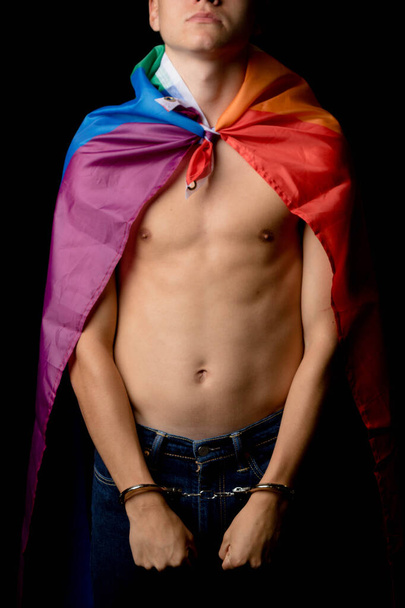A Shirtless 19 Year Old Teenage Boy wrapped in A Pride Flag Under Arrest - Fotoğraf, Görsel