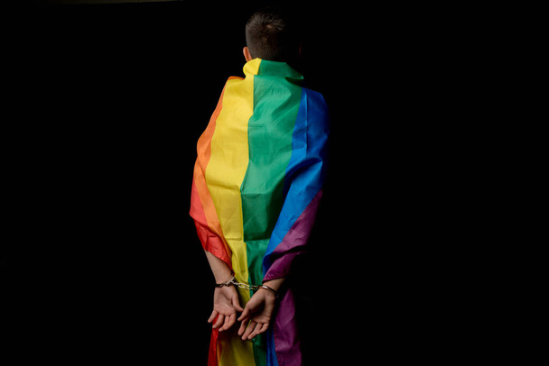 A Shirtless 19 Year Old Teenage Boy wrapped in A Pride Flag Under Arrest From Behind - Фото, зображення