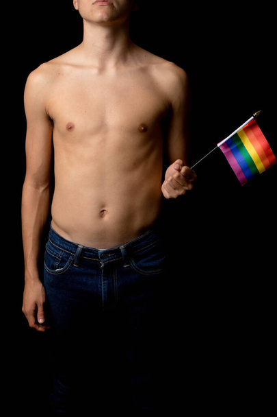 A Shirtless 19 Year Old Teenage Boy with Pride Flags - 写真・画像