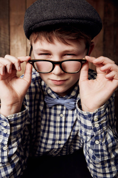 Im not sure I believe you...Young boy in retro clothing wearing spectacles with a suspicious expression - Photo, Image