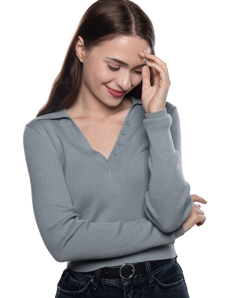 Embarrassed young woman covering face with hand on white background - Foto, imagen
