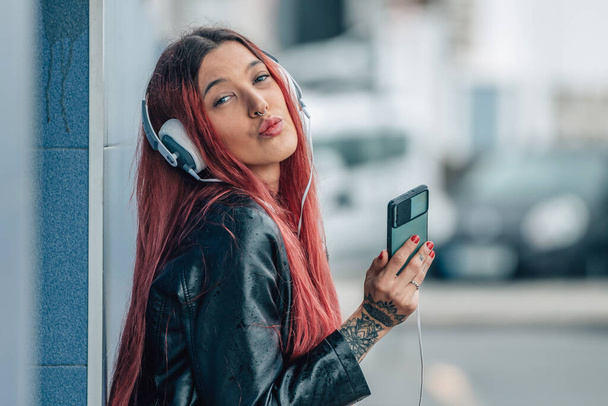 carefree redhead girl with mobile phone and headphones - Valokuva, kuva